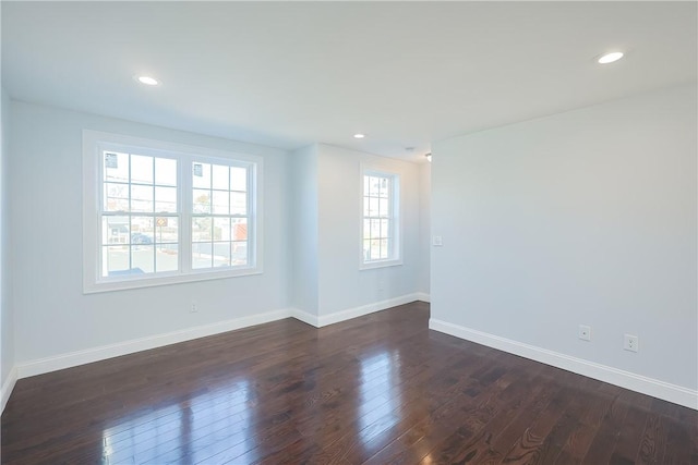 empty room with dark wood-type flooring