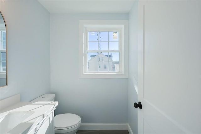 bathroom featuring tile patterned floors, vanity, and toilet