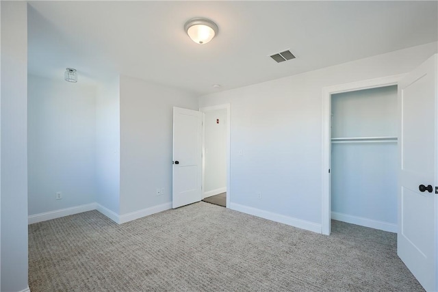 unfurnished bedroom featuring carpet floors and a closet