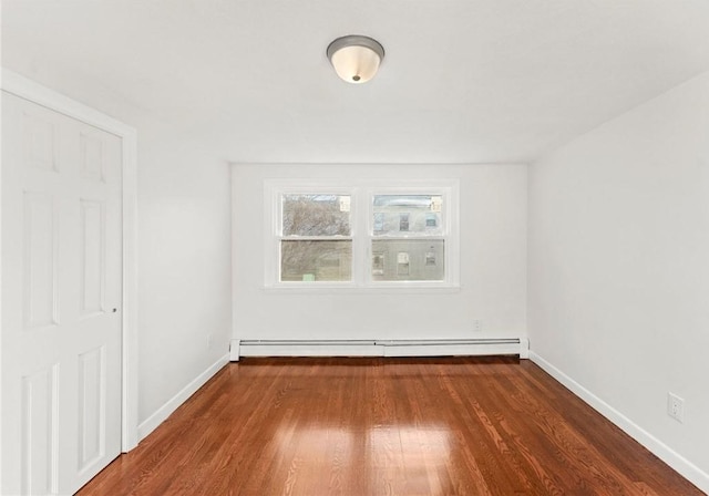 interior space with baseboard heating and dark hardwood / wood-style flooring