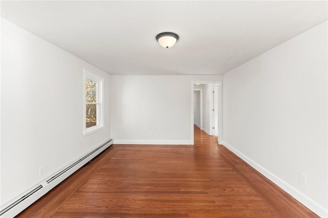 unfurnished room with hardwood / wood-style floors and baseboard heating