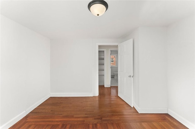 unfurnished room with dark hardwood / wood-style floors