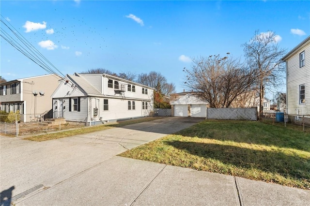 view of front of home with a front lawn, an outdoor structure, and a garage