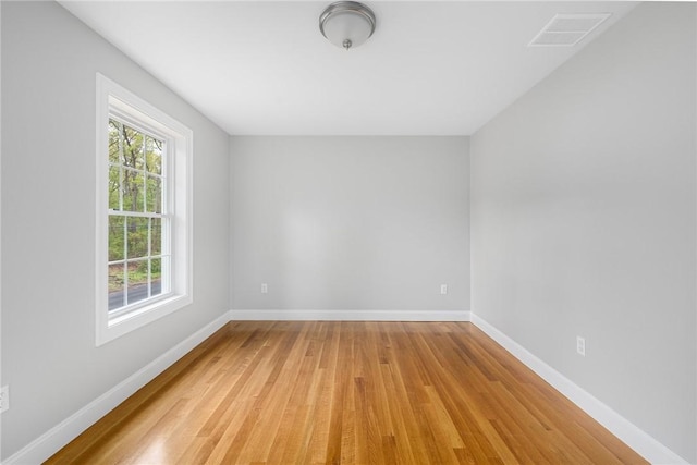 unfurnished room with light wood-type flooring