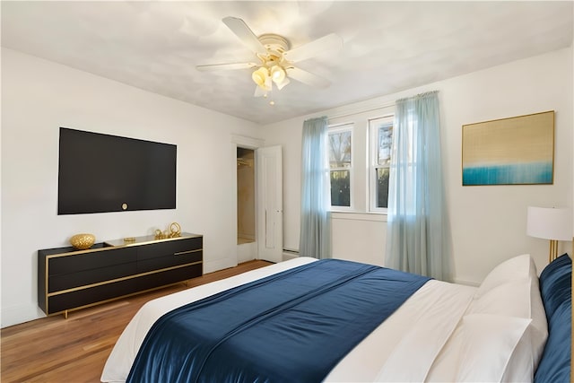 bedroom with hardwood / wood-style flooring and ceiling fan