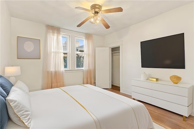 bedroom featuring ceiling fan, a closet, and light wood-type flooring