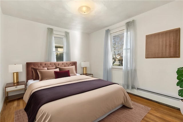 bedroom featuring light hardwood / wood-style floors and baseboard heating