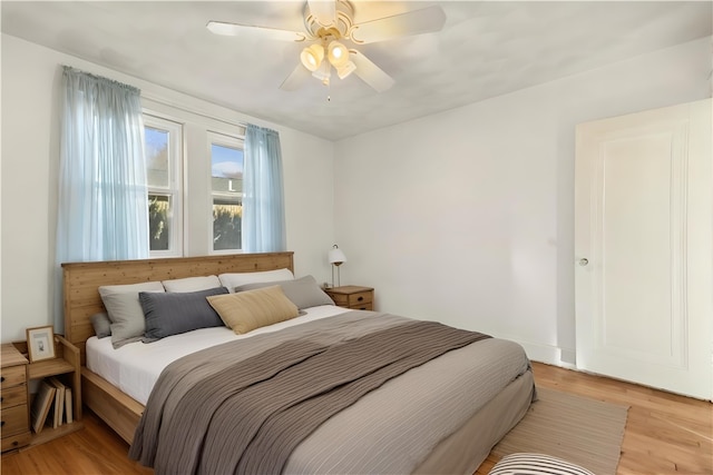 bedroom with light hardwood / wood-style flooring and ceiling fan