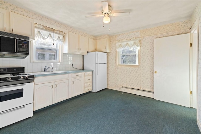 kitchen with ceiling fan, sink, a baseboard radiator, backsplash, and white appliances