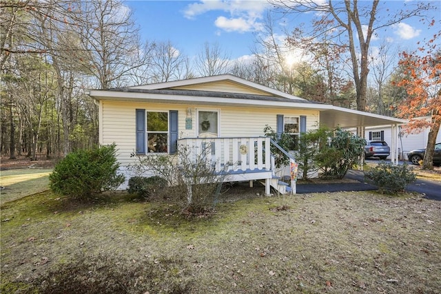 view of front of house with a front yard and a carport