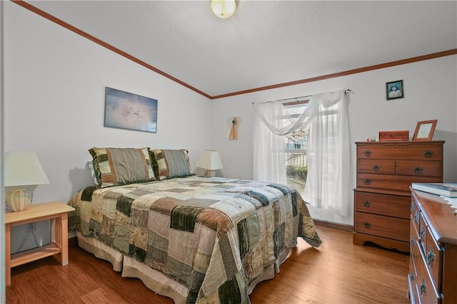 bedroom with light hardwood / wood-style flooring and ornamental molding