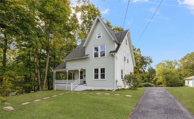 view of front of house featuring covered porch and a front yard