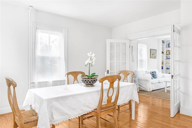 dining area featuring french doors and hardwood / wood-style flooring