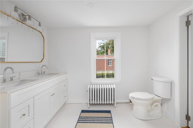 bathroom featuring radiator heating unit, vanity, and toilet