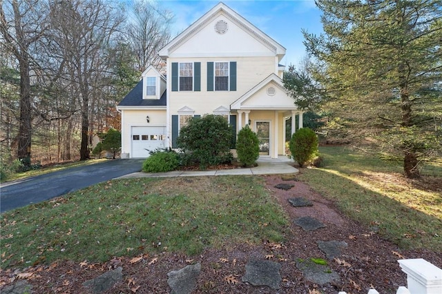 greek revival inspired property featuring a garage and a front lawn