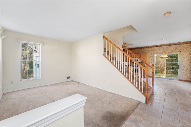 living room with ceiling fan and light colored carpet