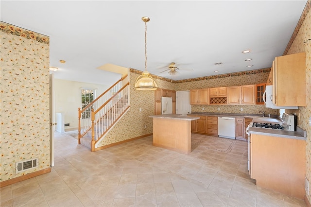 kitchen with ceiling fan, light tile patterned floors, white appliances, light brown cabinetry, and a kitchen island