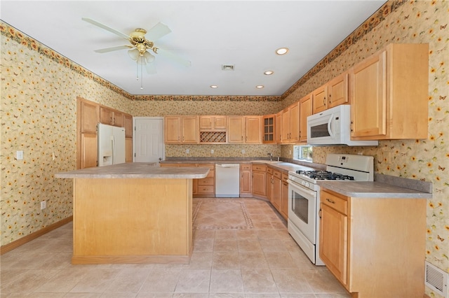 kitchen featuring ceiling fan, a center island, light brown cabinets, white appliances, and light tile patterned floors