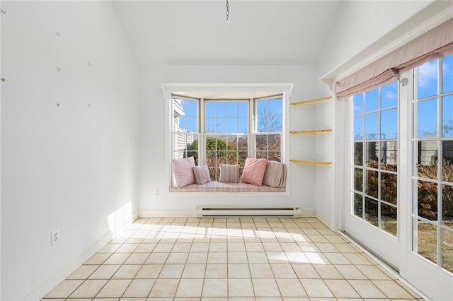 interior space with a baseboard radiator, vaulted ceiling, and a wealth of natural light