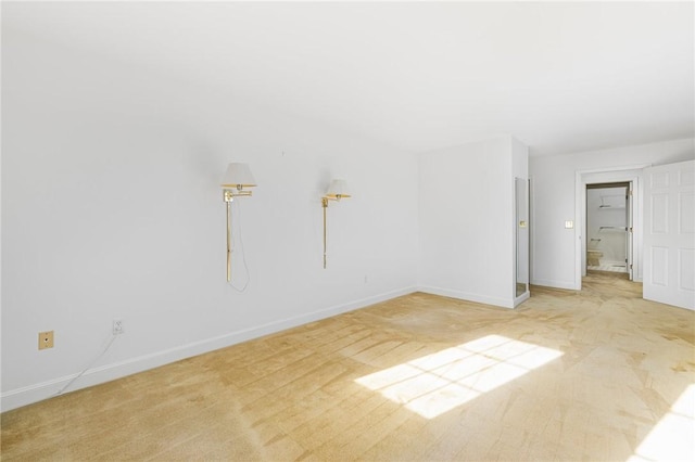 unfurnished room with light carpet