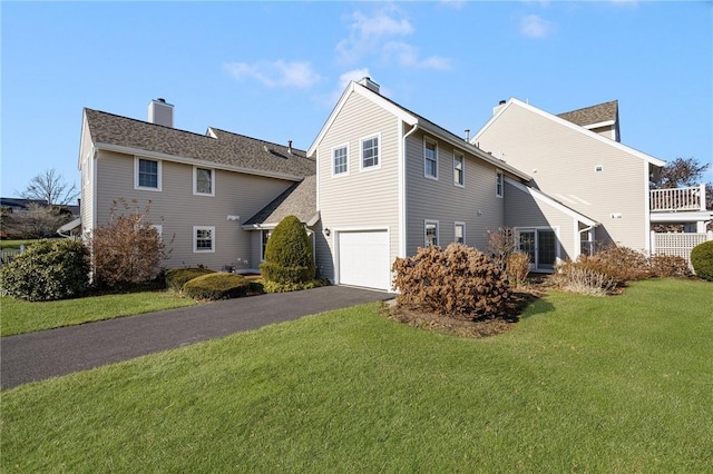 view of side of property with a yard and a garage