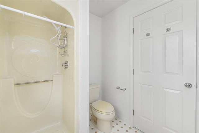 bathroom featuring walk in shower and toilet