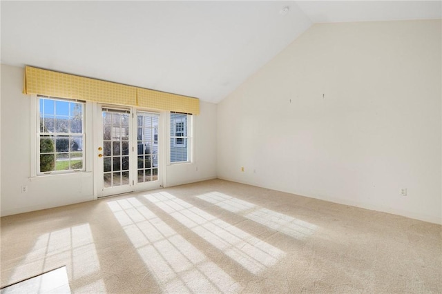 carpeted spare room with lofted ceiling