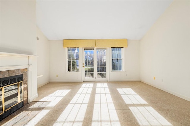 unfurnished living room with light carpet, a fireplace, and vaulted ceiling