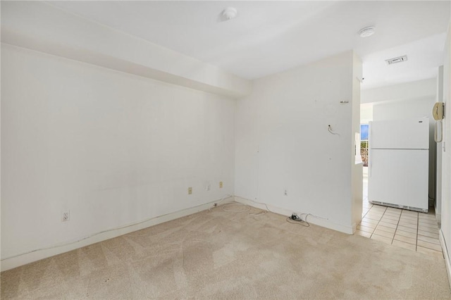 spare room featuring light colored carpet