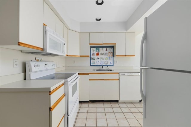 kitchen with white cabinetry, white appliances, sink, and light tile patterned floors