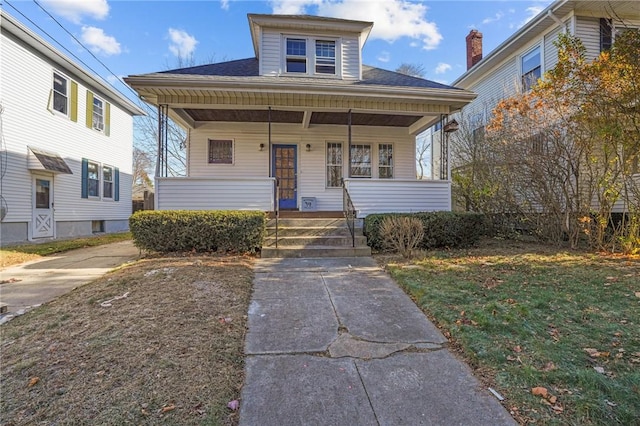 bungalow featuring a porch and a front yard