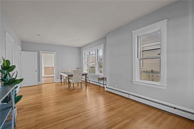 dining space featuring light hardwood / wood-style floors and a baseboard radiator