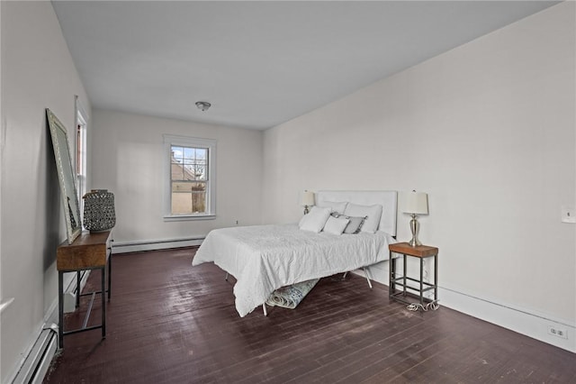 bedroom featuring baseboard heating and dark wood-type flooring