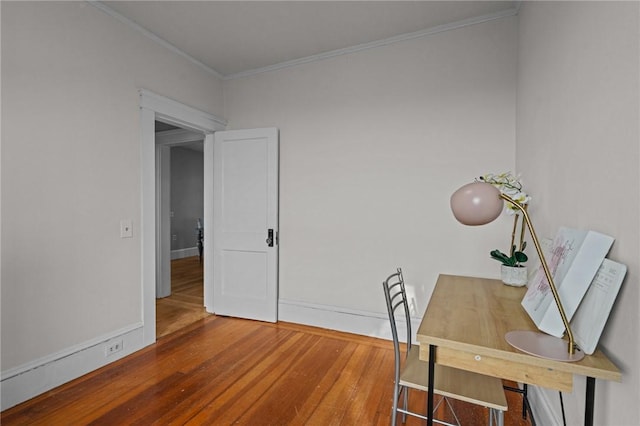 home office featuring wood-type flooring and crown molding