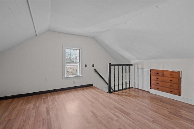 bonus room featuring hardwood / wood-style floors and vaulted ceiling