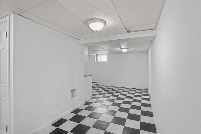 basement featuring a paneled ceiling