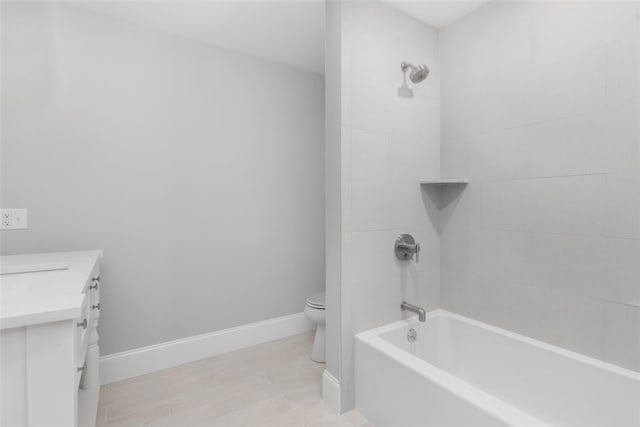 full bathroom featuring tile patterned flooring, vanity, toilet, and tiled shower / bath combo