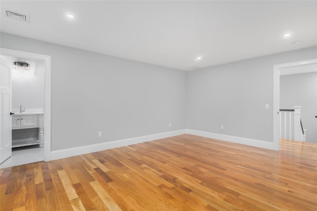 empty room with light hardwood / wood-style flooring