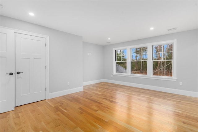 unfurnished room with light wood-type flooring