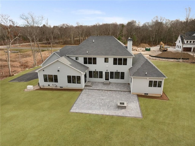 rear view of property featuring a lawn and a patio