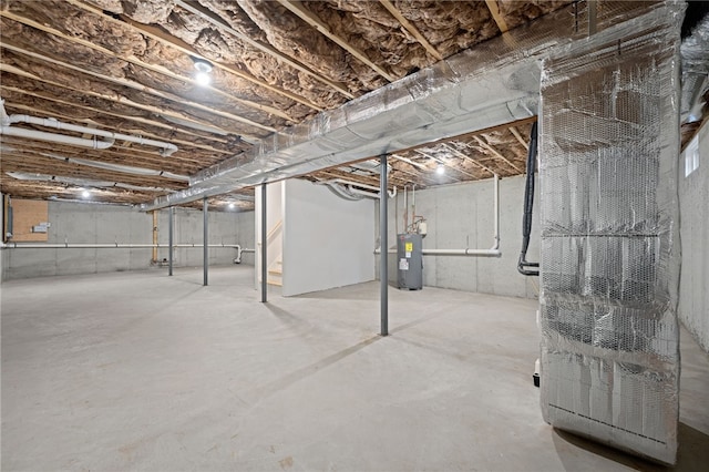 unfinished below grade area featuring water heater and stairway