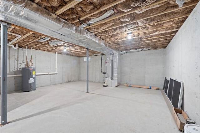 unfinished below grade area with electric water heater and heating unit