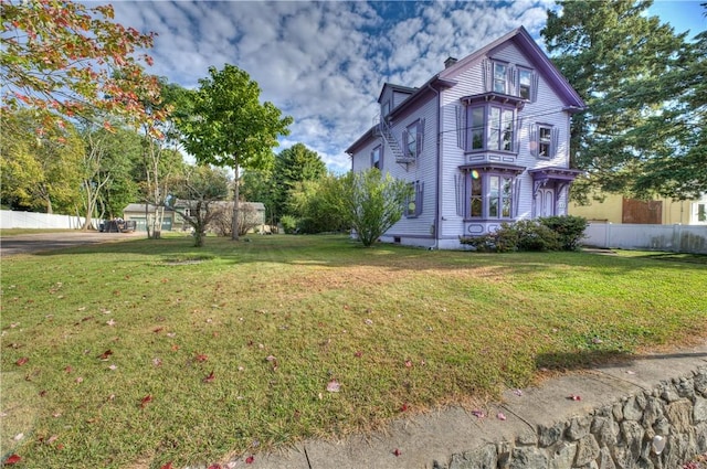 view of side of home featuring a yard