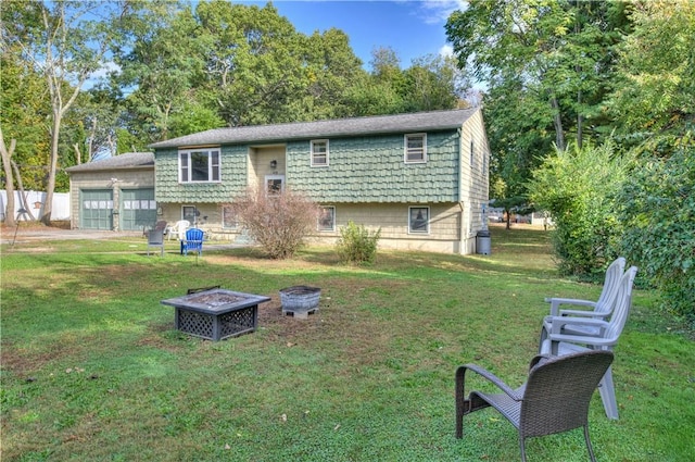 back of house with a fire pit and a yard