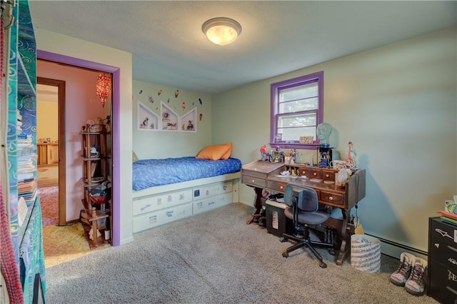 carpeted bedroom featuring a baseboard heating unit