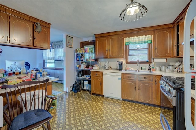 kitchen featuring white dishwasher, a healthy amount of sunlight, sink, and gas range