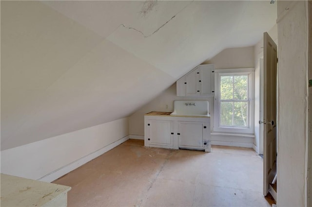 additional living space featuring lofted ceiling