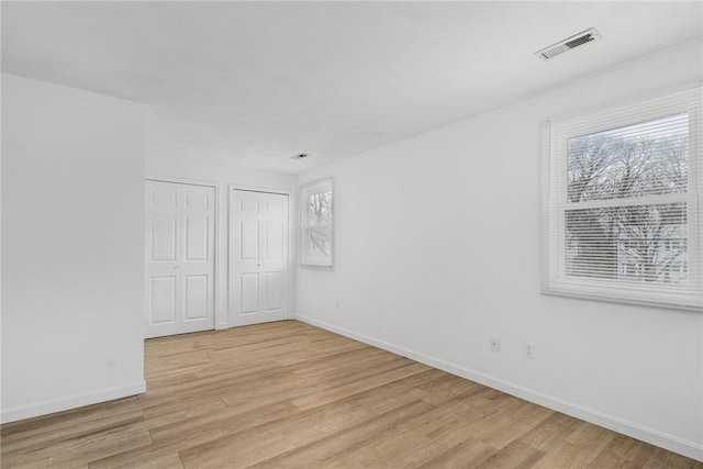 unfurnished room featuring light hardwood / wood-style flooring and a healthy amount of sunlight