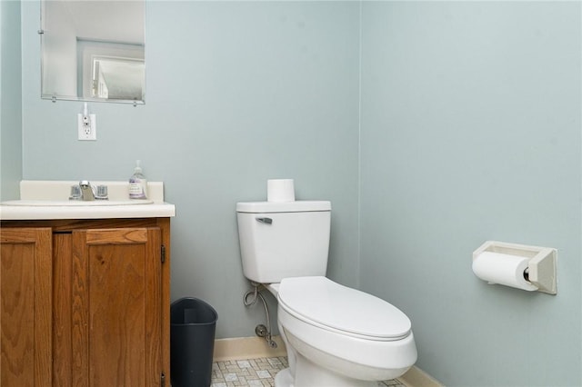 bathroom featuring tile patterned flooring, vanity, and toilet