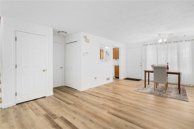 interior space with ceiling fan and light wood-type flooring